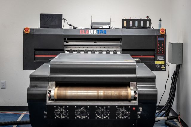 Gladiator direct-to-film (DTF) printer with its powder shaker and curing unit