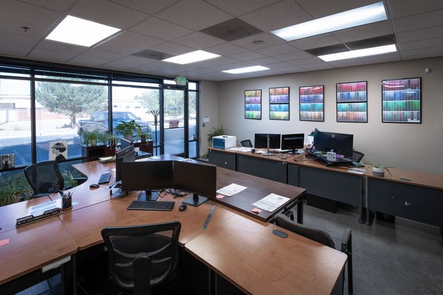 Silverscreen customer service office with desks, monitors and framed ink color charts