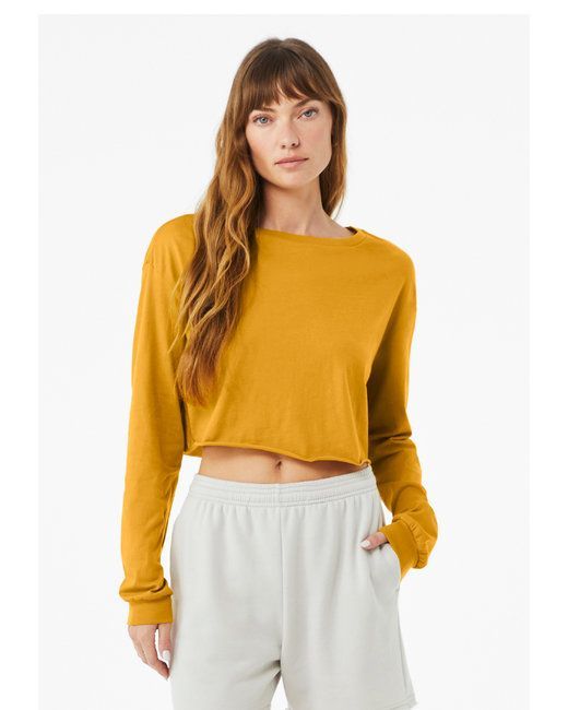 Woman in a mustard long-sleeve cropped top and light gray sweatpants
